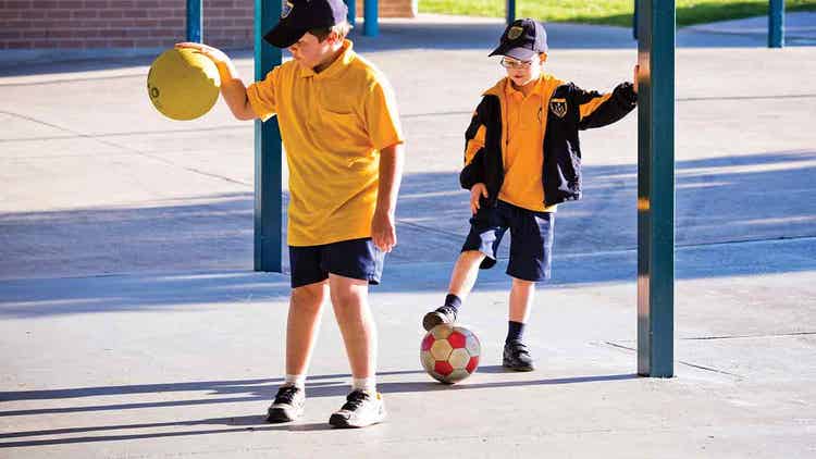 Two boys play on the basketball court at Uniting Outside School Hours Care Currans Hill